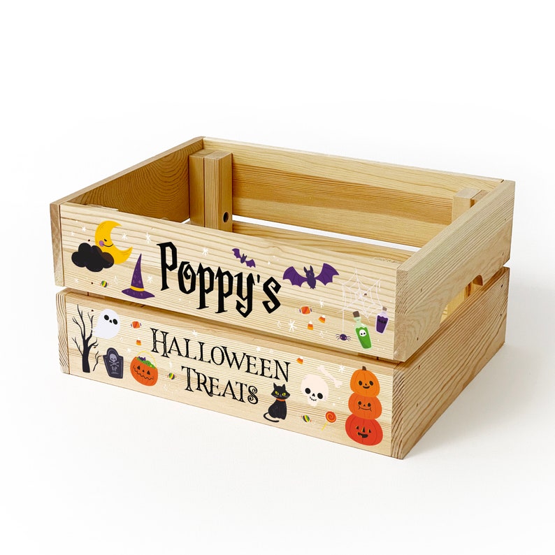 May include: A light-coloured wooden crate featuring Halloween-themed graphics and the text "Poppy's HALLOWEEN TREATS". The illustrations include a yellow moon, purple witch hat, bats, a ghost, a tombstone, pumpkins, a black cat, and a skull.