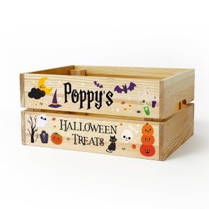 May include: A light-coloured wooden crate featuring Halloween-themed graphics and the text "Poppy's HALLOWEEN TREATS". The design includes a yellow crescent moon, a purple witch hat, bats, a ghost, a black cat, pumpkins, and various sweets.