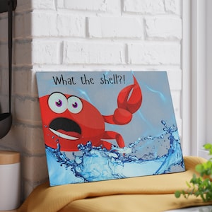May include: A rectangular canvas print featuring a cartoon crab in red with wide eyes and an open mouth, emerging from blue water. The text "What the shell?!" is above the crab.