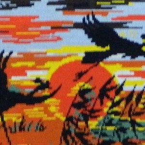 May include: A needlepoint tapestry depicting a sunset scene with four silhouetted birds in flight. The artwork features a vibrant color palette of orange, yellow, and black, with a small boat visible in the distance. The tapestry is a landscape scene.