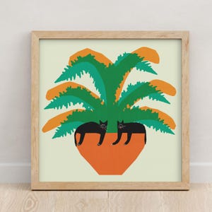 May include: Two black cats are lounging in a terracotta pot with a green and orange plant. The plant has large, leafy fronds.