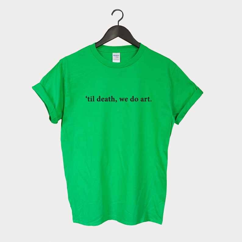 Peut inclure: Un t-shirt vert avec le texte "'til death, we do art." imprim&eacute; en noir.
