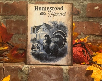 May include: A rustic wooden sign with the text "Homestead 1882 Harvest" and a vintage illustration of a farmhouse and turkeys.