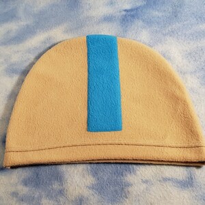 May include: A beige fleece beanie with a blue stripe down the center.