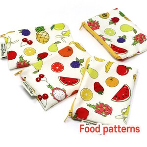 May include: Four zippered pouches with a white background and a colorful fruit pattern. The pouches are made in Canada and have the text "My Green" and "Made in Canada" on them. The pouches are arranged in a diagonal line with the text "Food patterns" at the bottom of the image.
