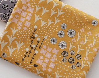 May include: A yellow fabric with a floral pattern. The fabric features pink flowers, white dots, and black stems. The background is a light yellow color.