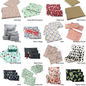 May include: A collection of 16 reusable snack bags with various floral and nature-themed prints. The bags are made of fabric and have a zipper closure. The bags are arranged in four rows of four. The bags are all different sizes and have different patterns. Some of the patterns include flowers, leaves, cacti, and birds. The bags are all labeled with their names.