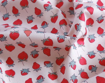 May include: Pink fabric with a repeating pattern of red strawberries. The strawberries are stylized and have a light blue stem and leaves.