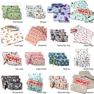May include: A collage of 15 different zippered pouches featuring various dog and dinosaur designs. The pouches are made of fabric and come in a variety of colors and patterns. Some of the pouches are labeled as "Sold Out".