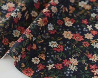 May include: Black fabric with a small-scale floral print in shades of red, orange, white, and green.
