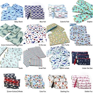 May include: A collection of 15 colorful zippered pouches with various animal and sea life designs. The pouches are made of fabric and have a zipper closure. The designs include baby sharks, blue fish, colorful fish, dolphins, dreaming whales, sea creatures, mini turtles, octopus and seahorses, seals, small fish, sperm whales, under the sea, whales, cute foxes, dashing foxes, and dollish foxes.