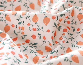 May include: Close-up of a white fabric with a repeating pattern of orange fruit and red berries. Green stems and leaves intertwine with the fruit, creating a botanical design. The fabric is slightly wrinkled, showing its texture.