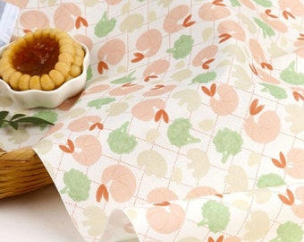 May include: White fabric with a repeating pattern of pink and green shapes. The fabric has a subtle diamond pattern.