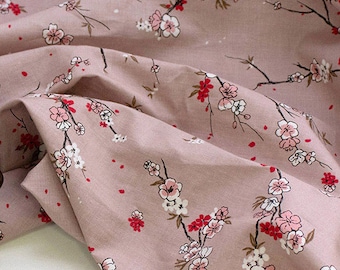 May include: Pink fabric with a white and pink floral print. The fabric features a repeating pattern of small flowers and branches.