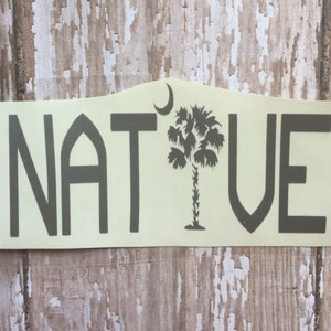 May include: A light yellow sticker with the word "NATIVE" in black text. A black silhouette of a palm tree with a crescent moon above it is between the "T" and the "V".