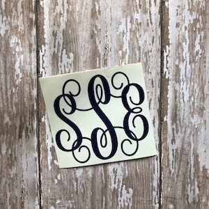 May include: A white sticker with a black monogram of the letters "S S E" in a cursive script font.