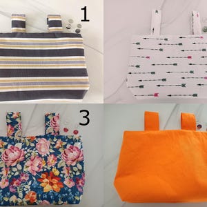 May include: Four fabric tote bags with attached handles are displayed. The bags feature different patterns: a striped design in gray, white, and gold; arrows on white; a floral print; and a solid orange color. Buttons are scattered around the bags.