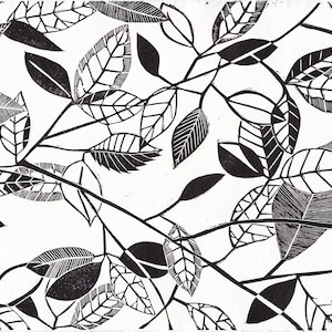 May include: Black and white linocut print of stylized leaves and branches. The print features a repeating pattern of leaves with intricate details.
