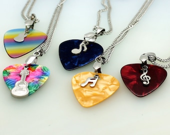 May include: Four guitar pick necklaces with different coloured picks and charms. The picks are rainbow, blue, yellow, and red. The charms are a guitar, a treble clef, and a bass clef.