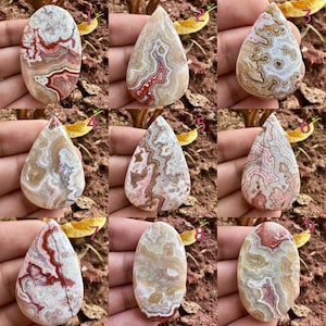 May include: Nine polished gemstone cabochons in various shapes, showcasing intricate patterns of red, brown, and cream colors. Each stone displays unique veining and banding, with a smooth, glossy finish. The gemstones are displayed against a natural background.