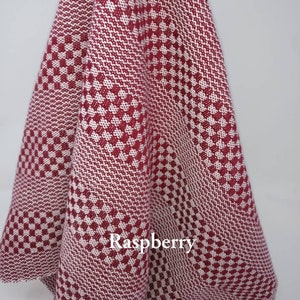 May include: A red and white checkered kitchen towel with the word "Raspberry" printed on it.