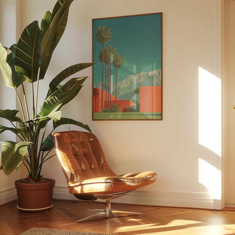 May include: A mid-century modern living room scene featuring a brown leather chair with a chrome base, a large potted plant, and a framed art print depicting palm trees and mountains. The room has a warm, inviting atmosphere with natural light.