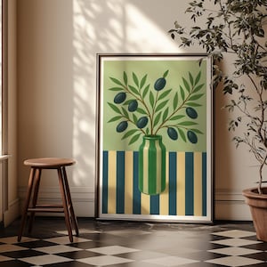 May include: A framed art print featuring a still life of olives. The artwork depicts a green and white striped vase holding olive branches with dark olives against a light green background. The bottom of the print has blue and yellow stripes.