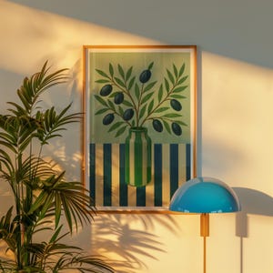 May include: A framed art print featuring a vase with olive branches and olives. The vase is green and white striped, set against a striped background of blue and white. The artwork is in a wooden frame.