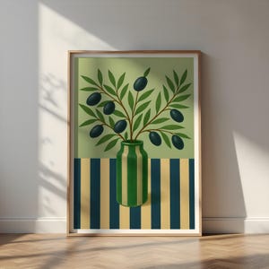 May include: A framed art print featuring a still life of olives. The artwork depicts a green and white striped vase holding olive branches with dark green olives. The background is divided into green and striped sections, with a wooden frame.