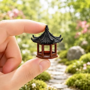 May include: A miniature hexagonal pavilion featuring a dark brown base and a black, multi-tiered, curved roof with intricate tile detailing. The structure has open sides and a central support column, designed as a small-scale architectural model.