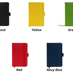 May include: Five small notebooks in different colors: black, yellow, green, red, and navy blue. Each notebook has a ribbon bookmark and a closure strap.