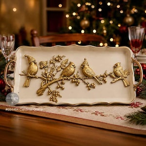 May include: A rectangular cream-coloured serving tray with gold-toned handles and a raised relief design of four birds perched on a branch with berries. Two of the birds wear small hats. The text "re-design" and "#684464 Cardinal Grace" is visible.
