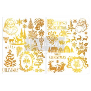 May include: A sheet of gold-colored decals featuring various Christmas-themed illustrations including Santa Claus faces, reindeer, pine trees, snowflakes, bells, houses, and the text Merry Christmas in a decorative font style throughout the design.