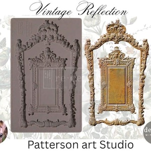 May include: A silicone mold for making decorative resin frames. The mold is shaped like a vintage ornate frame with a smaller frame inside. The mold is gray and has a smooth surface. The text "Vintage Reflection" is printed on the top of the mold.