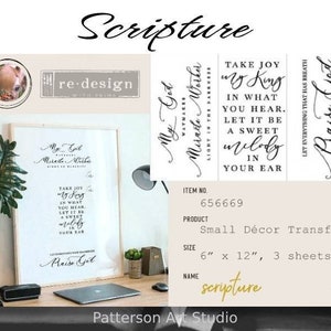 May include: A framed print and three small décor transfer sheets with inspirational quotes in black script. The framed print is on a desk with a laptop and a plant. The transfer sheets are 6" x 12". The product name is "Scripture".