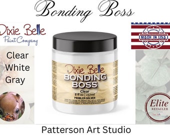 May include: A clear glass jar of Dixie Belle Bonding Boss Clear Problem Solver, a paint additive. The jar is labeled with the Dixie Belle logo and the product name. The jar is 8 fluid ounces (237 ml).