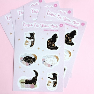 May include: A set of five sticker sheets featuring black and white cats with celestial designs. The stickers are on a white background with gold accents. The text on the sticker sheet reads "Celestial Cat Sticker Sheet" and "www.glitterpunk.co.uk".