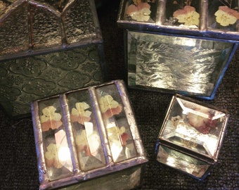 Stained glass boxes with real pressed and dried flowers in them between bevels