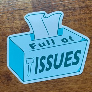 May include: A blue and white tissue box with the text "Full of Issues" in green lettering.