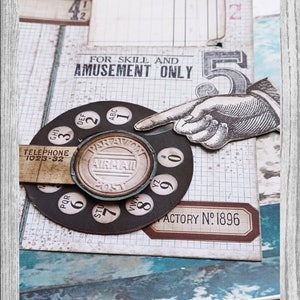 May include: A vintage-style rotary phone dial with a brown and black color scheme. The dial has numbers 0-9 and letters ABC, DEF, GHI, JKL, MNO, PQR, STU, VWX, YZ. The dial is surrounded by a gridded paper background with the text "FOR SKILL AND AMUSEMENT ONLY" and "FACTORY NO: 1896".