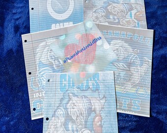 May include: Notebook paper sheets with Indianapolis Colts graphics. The sheets feature the Colts logo, team name, and player illustrations in blue and white. The sheets have a lined design with three-hole punches.