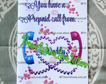 May include: A white rectangular greeting card featuring the blue text "You have a Prepaid call from..." above two telephone handsets, one blue and one pink, connected by a purple coiled cord forming a heart shape, surrounded by pink hearts.