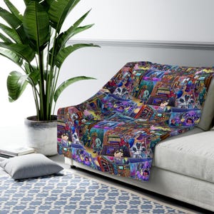 May include: A colorful throw blanket with a repeating pattern of cartoon characters and objects. The blanket features a variety of colors, including purple, blue, green, yellow, and red. The characters and objects are all drawn in a whimsical style.
