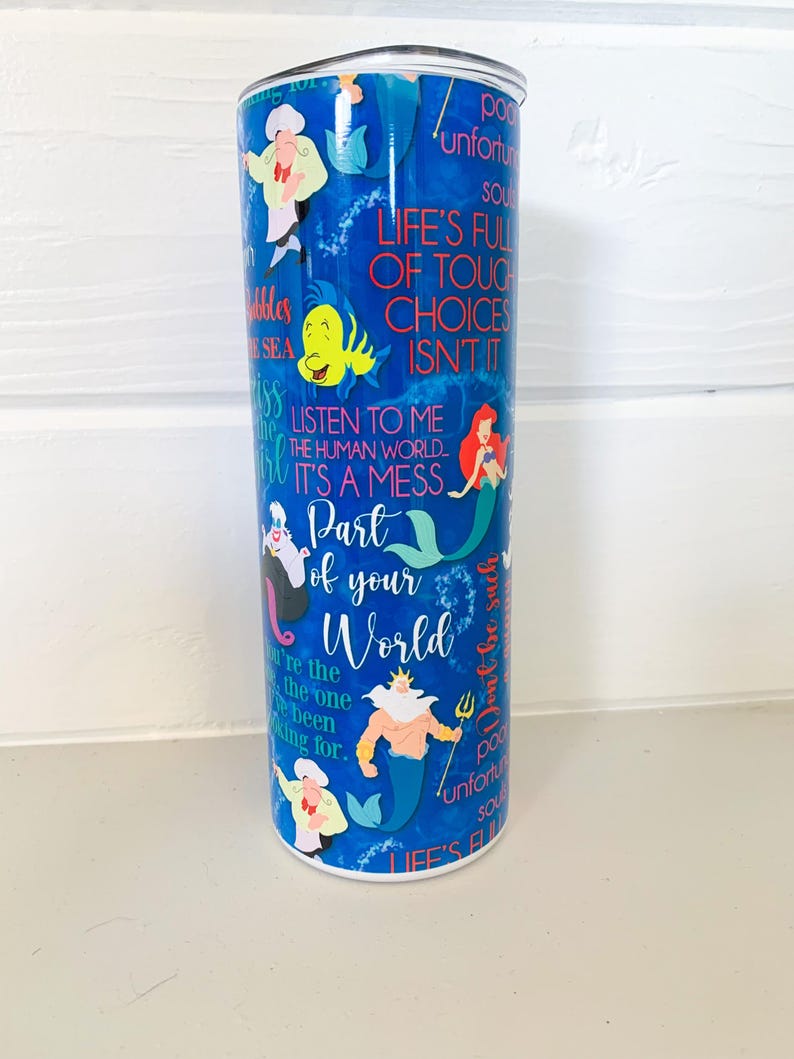 K&ouml;nnte beinhalten: Blauer Edelstahl-Reisebecher mit Charakteren und Zitaten aus Arielle, die Meerjungfrau. Das Design zeigt Arielle, Fabius und Ursula, mit S&auml;tzen wie "Part of your World" und "It's a mess."