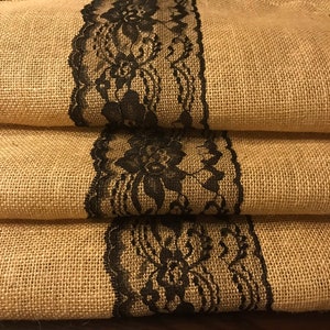 May include: Three burlap table runners with black lace trim. The lace has a floral design.