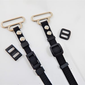 May include: Two black adjustable straps with silver metal loops and black plastic buckles. The straps have silver metal studs.