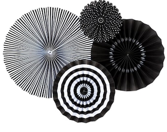 May include: Set of four black and white paper fan decorations. The fans feature different patterns, including stripes, polka dots, and a diamond pattern.