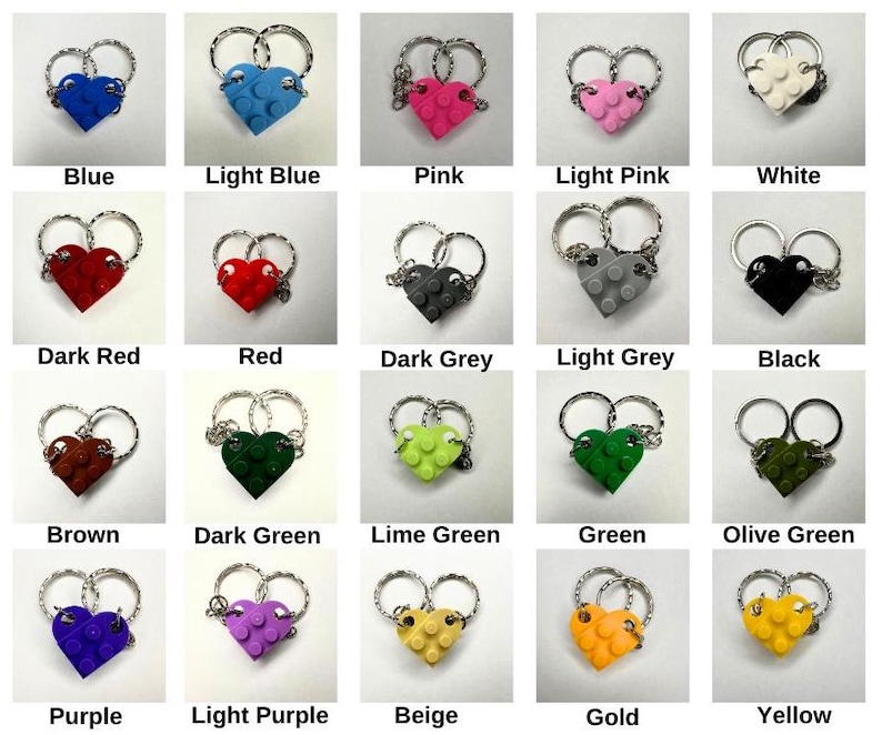 May include: A selection of heart-shaped keyrings in diverse colours, such as blue, pink, red, and green. Each keyring is constructed from interlocking blocks and has a silver-tone ring. The image includes labels with the colour names.
