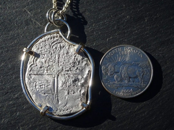 Treasure coin necklace. The coin is from 1786 and was salvaged from the  shipwreck of the El Cazador in the Gulf of Mexico. - Picture of Touch of  Gold, Aruba - Tripadvisor