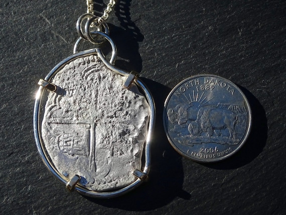 Treasure coin necklace. The coin is from 1786 and was salvaged from the  shipwreck of the El Cazador in the Gulf of Mexico. - Picture of Touch of  Gold, Aruba - Tripadvisor